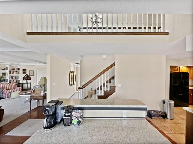 interior space featuring a chandelier, stairway, and a towering ceiling