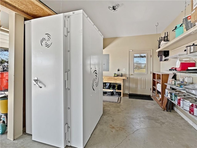 interior space featuring open shelves, unfinished concrete flooring, and white cabinets
