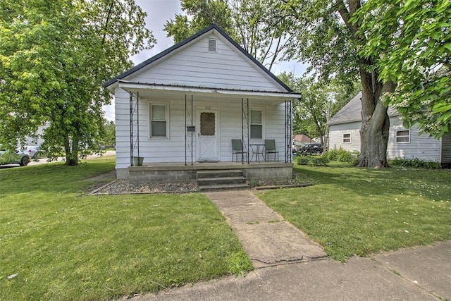 1212 Washington St, Clinton, IL 61727 - view of front of home featuring a porch and a front yard