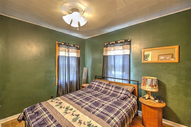 1212 Washington St, Clinton, IL 61727 - bedroom with wood finished floors and crown molding