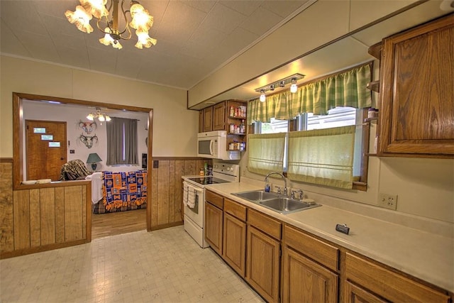 1212 Washington St, Clinton, IL 61727 - kitchen featuring white appliances, a chandelier, wainscoting, brown cabinetry, and ornamental molding