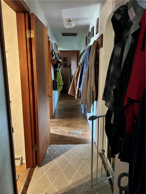 hallway with hardwood / wood-style floors and baseboard heating