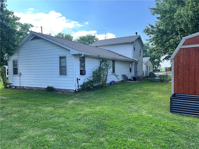 back of house featuring a lawn