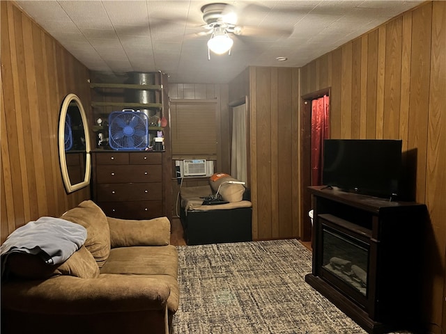 living room with ceiling fan, wood walls, and cooling unit