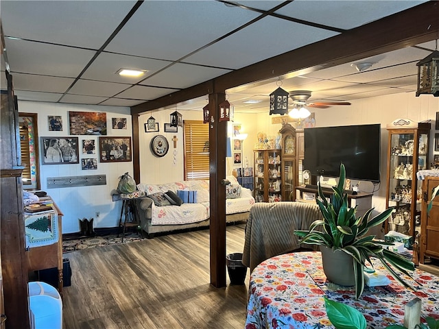 living room with ceiling fan, hardwood / wood-style floors, and a drop ceiling