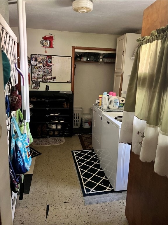 clothes washing area with washing machine and dryer