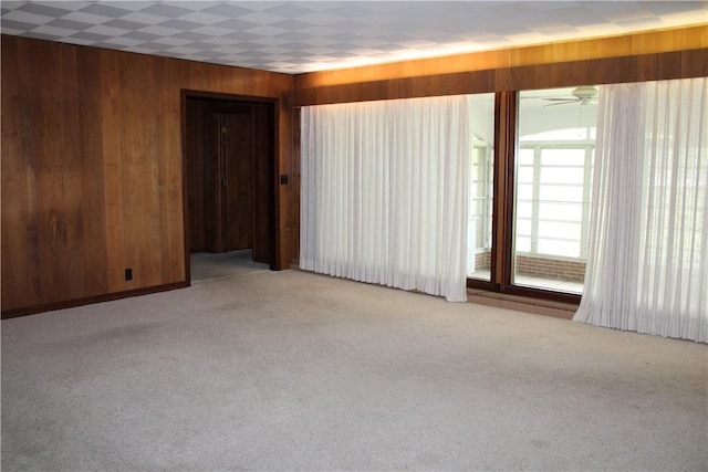 1011 W N 3rd St, Shelbyville, IL 62565 - spare room featuring wooden walls, light carpet, and a ceiling fan