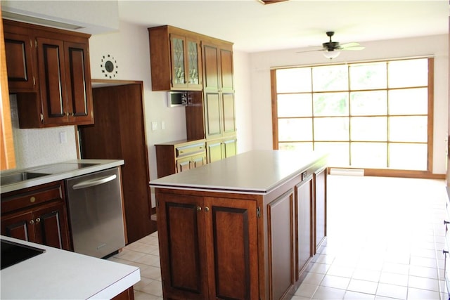 1011 W N 3rd St, Shelbyville, IL 62565 - kitchen featuring stainless steel dishwasher, light countertops, light tile patterned floors, a ceiling fan, and glass insert cabinets