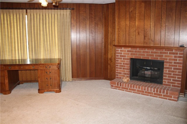 1011 W N 3rd St, Shelbyville, IL 62565 - living room featuring light colored carpet, a fireplace, a ceiling fan, a desk, and wooden walls