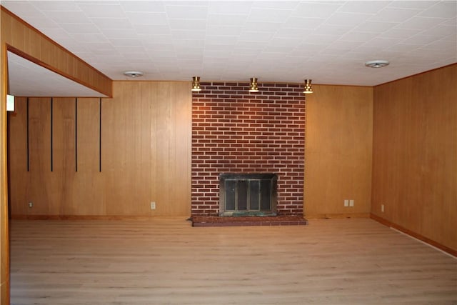 1011 W N 3rd St, Shelbyville, IL 62565 - finished basement with wood finished floors, wood walls, a brick fireplace, and baseboards