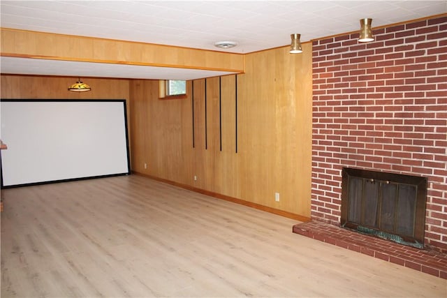 1011 W N 3rd St, Shelbyville, IL 62565 - unfurnished living room featuring wood finished floors, wooden walls, a brick fireplace, and baseboards