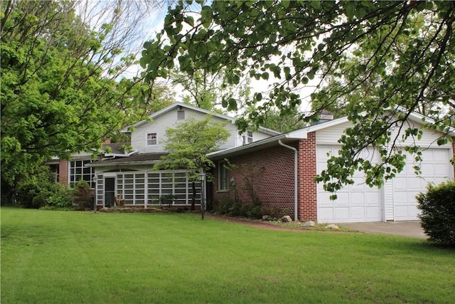 1011 W N 3rd St, Shelbyville, IL 62565 - rear view of house with brick siding, a yard, an attached garage, and concrete driveway