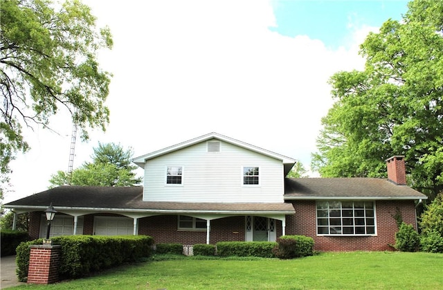 1011 W N 3rd St, Shelbyville, IL 62565 - view of front of house featuring an attached garage, a front yard, brick siding, and a chimney