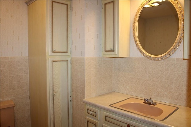 1011 W N 3rd St, Shelbyville, IL 62565 - bathroom with tile walls, wallpapered walls, vanity, and a wainscoted wall