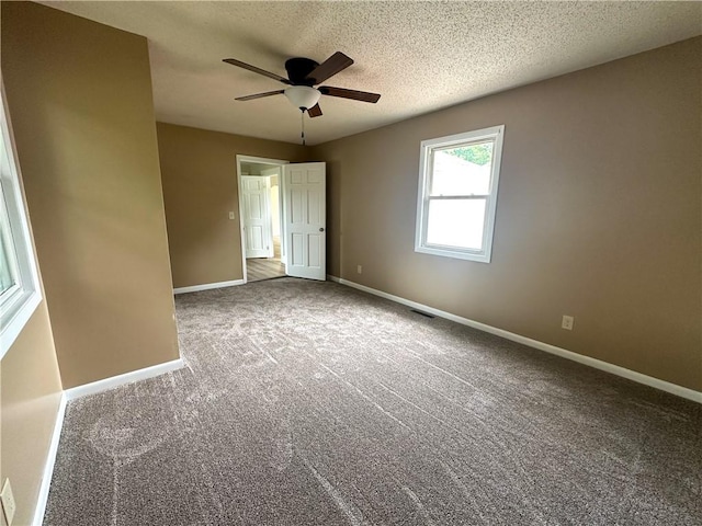 126 E Elliott St, Paris, IL 61944 - empty room featuring ceiling fan, carpet flooring, and a textured ceiling