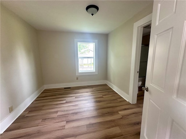126 E Elliott St, Paris, IL 61944 - empty room with wood finished floors and baseboards