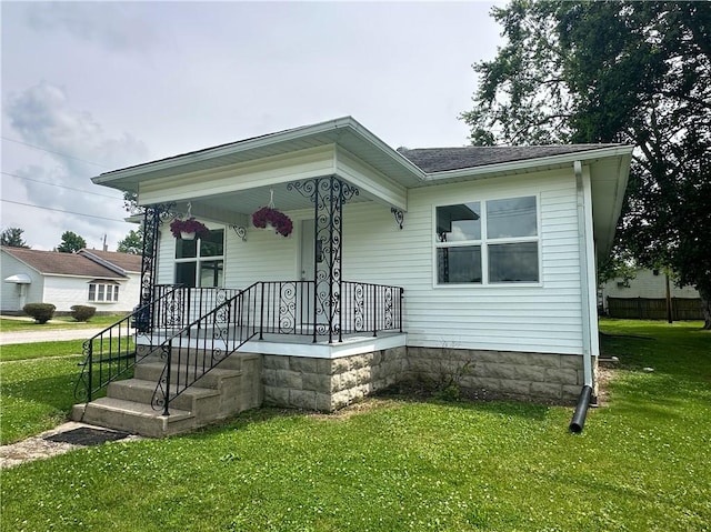 126 E Elliott St, Paris, IL 61944 - view of front of house with a front lawn and covered porch