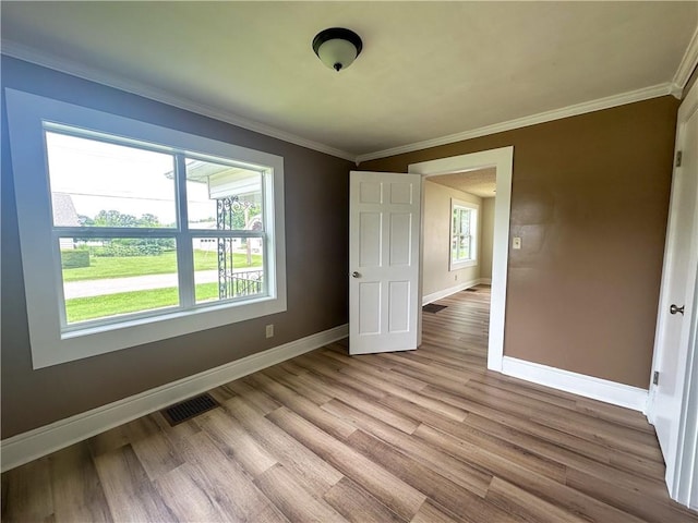 126 E Elliott St, Paris, IL 61944 - unfurnished bedroom with wood finished floors and ornamental molding