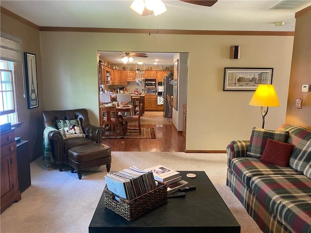 303 S Pine St, Pana, IL 62557 - living area featuring a ceiling fan, light colored carpet, ornamental molding, and baseboards
