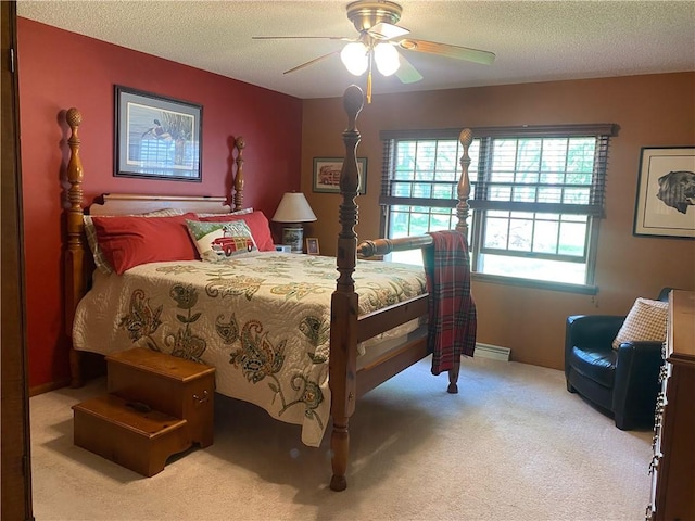 303 S Pine St, Pana, IL 62557 - carpeted bedroom with multiple windows, a textured ceiling, ceiling fan, and a baseboard radiator