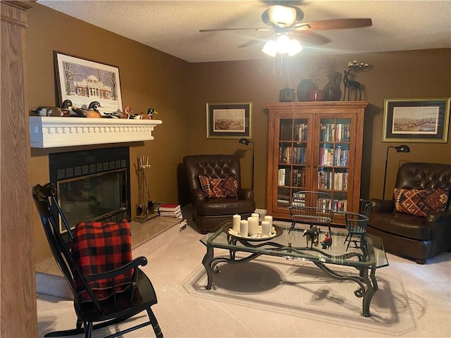 303 S Pine St, Pana, IL 62557 - living area featuring carpet floors, ceiling fan, a textured ceiling, and a glass covered fireplace