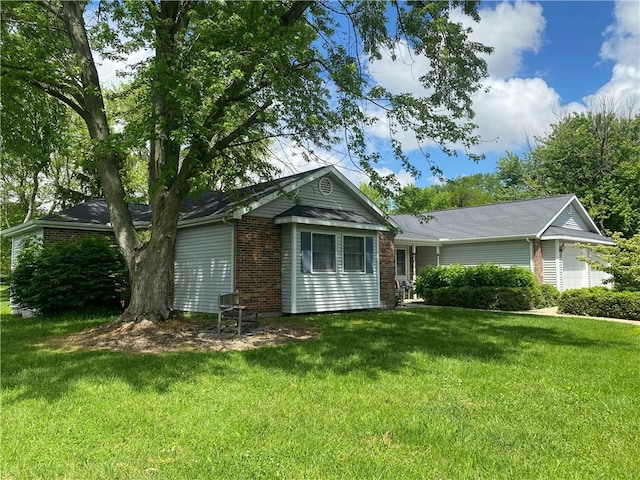 303 S Pine St, Pana, IL 62557 - ranch-style home with a front yard and brick siding