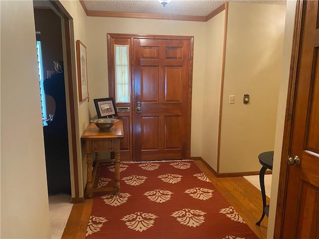 303 S Pine St, Pana, IL 62557 - entryway featuring light wood finished floors and a textured ceiling