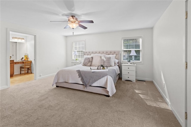 309 Santa Barbara Dr, Effingham, IL 62401 - carpeted bedroom featuring multiple windows, a ceiling fan, and ensuite bath