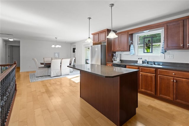 309 Santa Barbara Dr, Effingham, IL 62401 - kitchen with freestanding refrigerator, light wood finished floors, a kitchen island, decorative light fixtures, and a chandelier