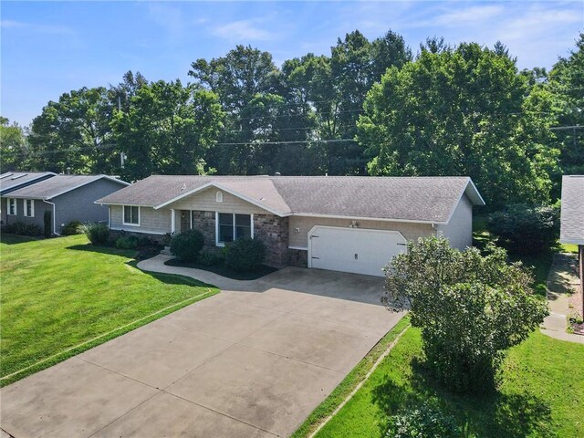 309 Santa Barbara Dr, Effingham, IL 62401 - single story home with stone siding, a garage, concrete driveway, and a front yard