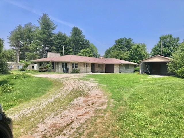 900 W Cumberland Rd, Saint Elmo, IL 62458 - view of front of home with driveway, a front yard, and a chimney