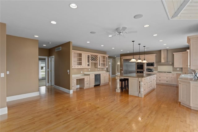 17212 Stonecreek Dr, Effingham, IL 62401 - kitchen with wall chimney range hood, a sink, a breakfast bar, wine cooler, and built in appliances