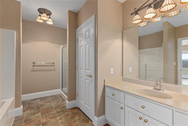 17212 Stonecreek Dr, Effingham, IL 62401 - full bathroom featuring a shower with door, baseboards, vanity, stone finish flooring, and a tub