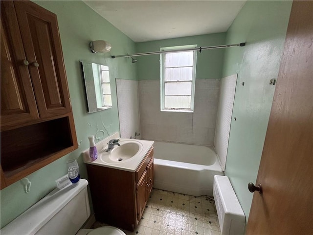 bathroom featuring toilet, radiator heating unit, shower / bathtub combination, and vanity