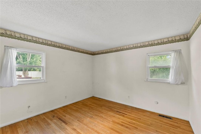 2701 E Rd, Danville, IL 61832 - spare room with light wood finished floors and a textured ceiling