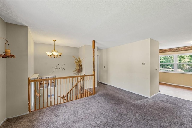 2701 E Rd, Danville, IL 61832 - empty room featuring carpet, a chandelier, and a textured ceiling