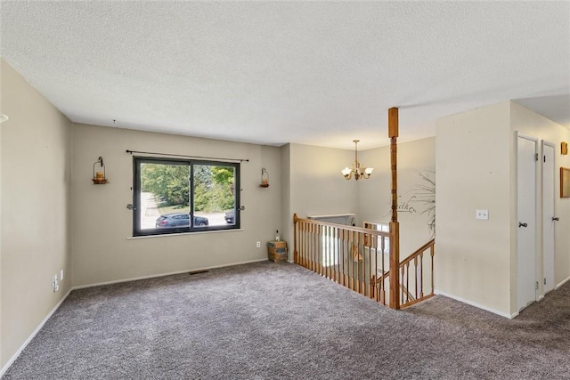 2701 E Rd, Danville, IL 61832 - spare room featuring carpet floors, a chandelier, and a textured ceiling