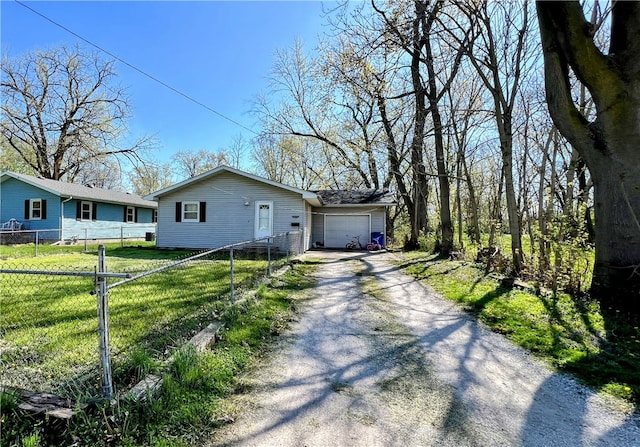 view of front of house with a front yard and a garage