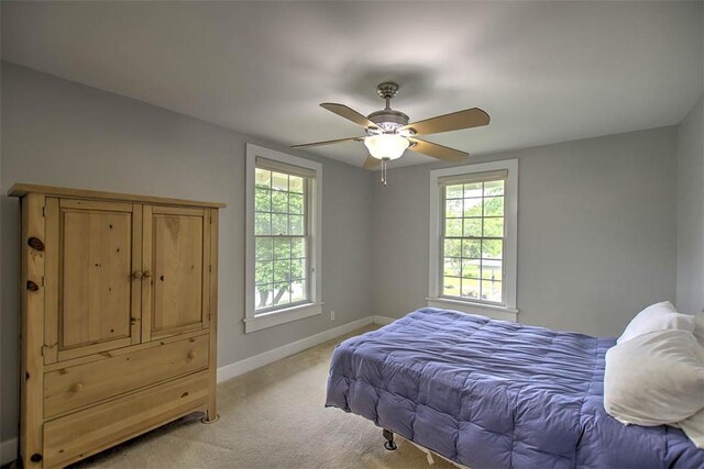 2064 William St, Decatur, IL 62522 - bedroom with baseboards, light colored carpet, and a ceiling fan