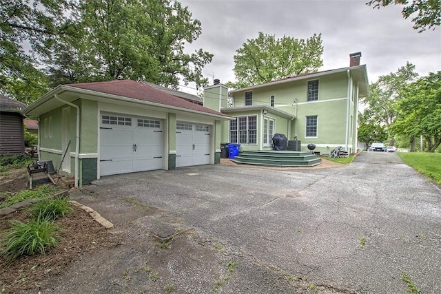 2064 William St, Decatur, IL 62522 - back of house with a chimney and a detached garage