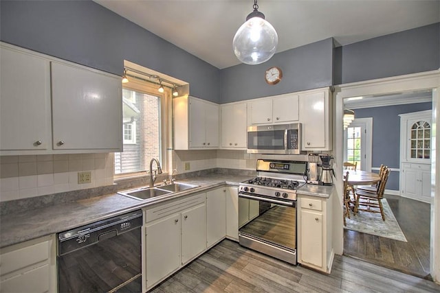 2064 William St, Decatur, IL 62522 - kitchen with stainless steel appliances, a sink, decorative backsplash, and white cabinetry