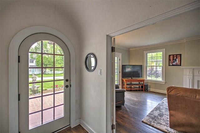 2064 William St, Decatur, IL 62522 - entryway featuring dark wood-style flooring, crown molding, baseboards, and arched walkways