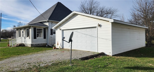 view of side of home with a lawn and a garage