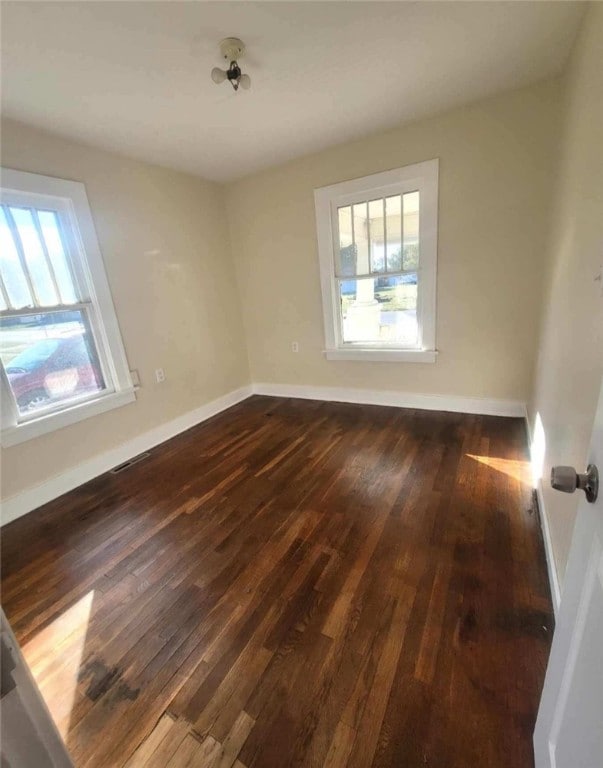 spare room with dark hardwood / wood-style flooring