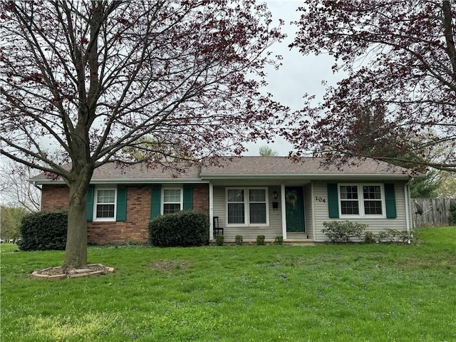 ranch-style house with fence and a front yard