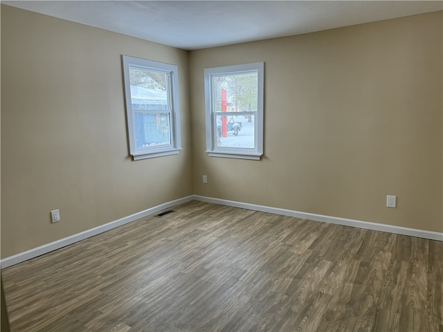 unfurnished room with hardwood / wood-style flooring