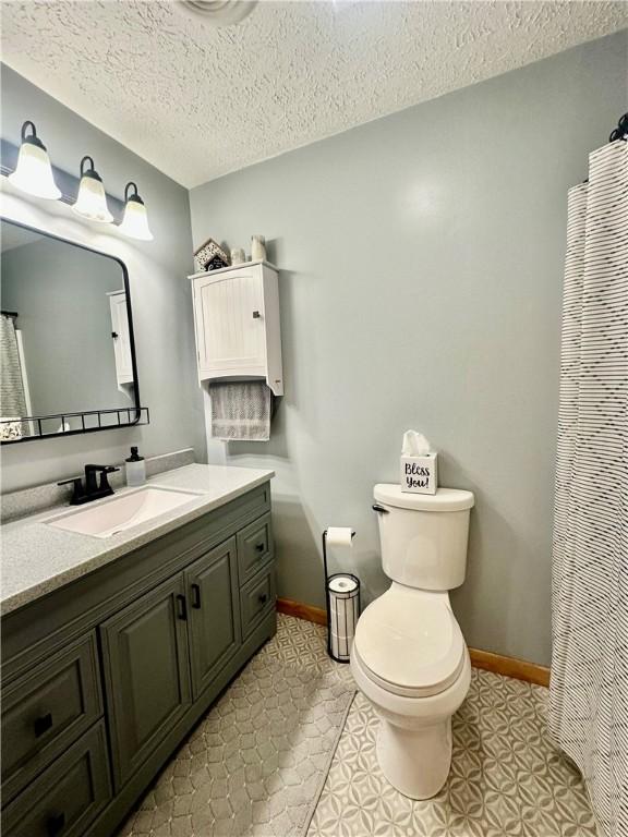 31508 1800 E Rd, Rossville, IL 60963 - bathroom featuring vanity, a textured ceiling, and a shower with curtain