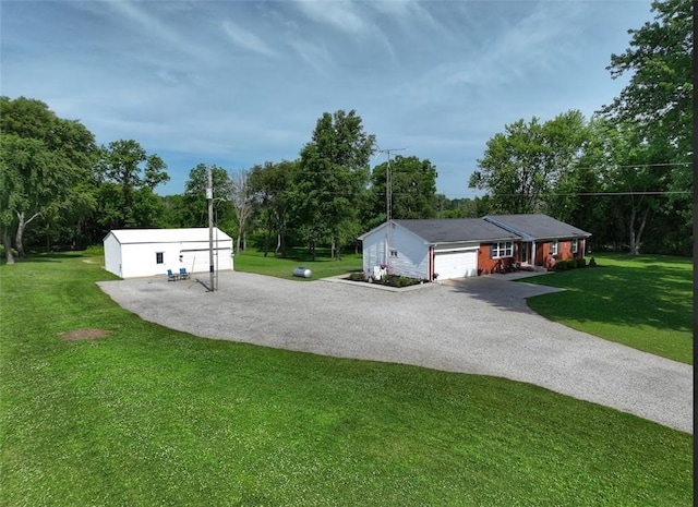 31508 1800 E Rd, Rossville, IL 60963 - view of green lawn with driveway, view of wooded area, and an outbuilding