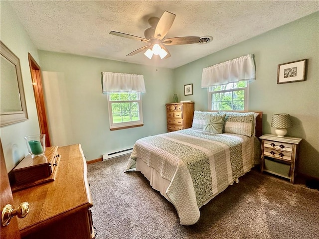31508 1800 E Rd, Rossville, IL 60963 - bedroom with dark carpet, multiple windows, a baseboard radiator, a textured ceiling, and ceiling fan