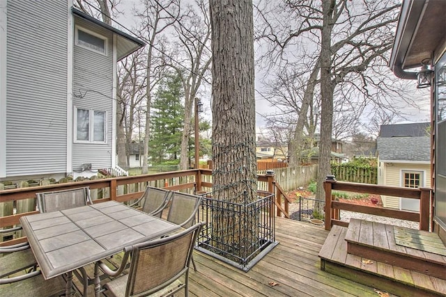 deck with fence and outdoor dining area